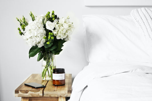 Flowers, Candle and Phone on Nightstand